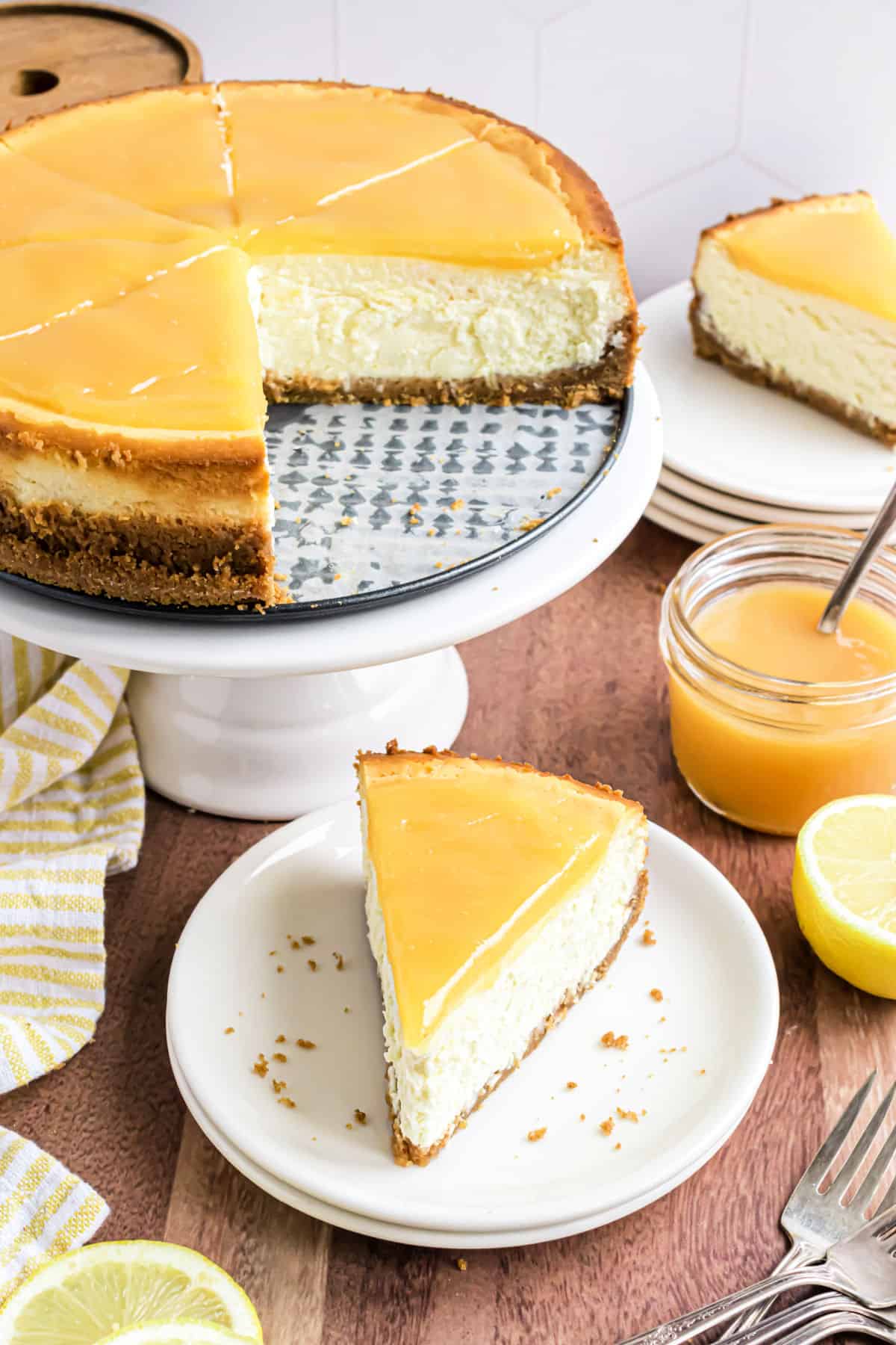 Slices of lemon cheesecake served on white dessert plates.