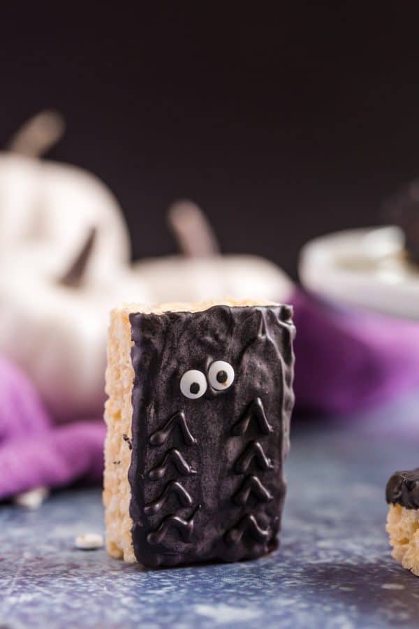 Spooky Halloween Rice Krispie Treats with chocolate spider decorations.