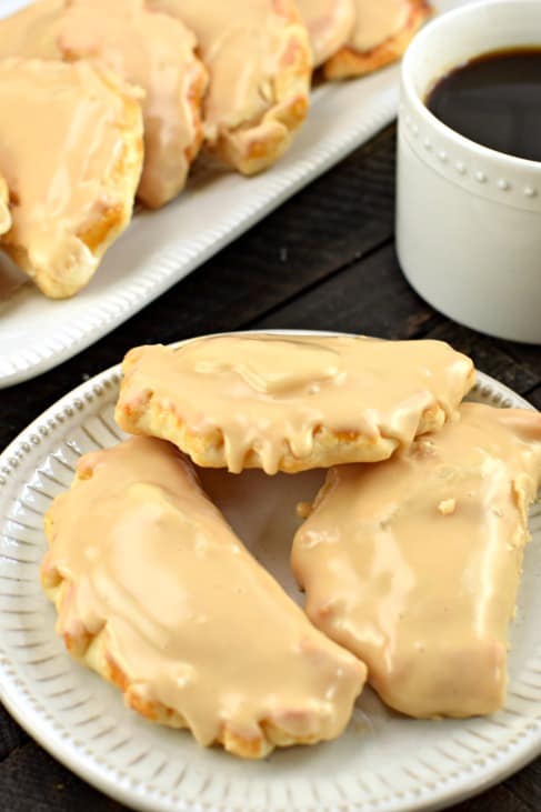 Apple Empanadas with caramel frosting on a white plate