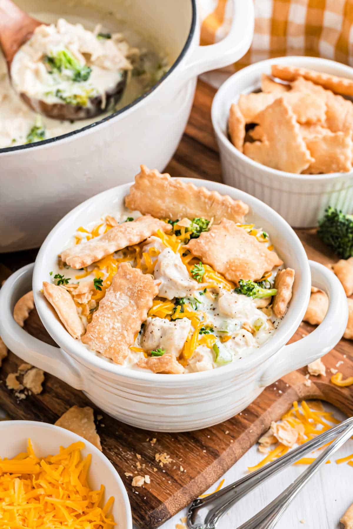 Chicken soup served with pie crust strips on a white bowl.