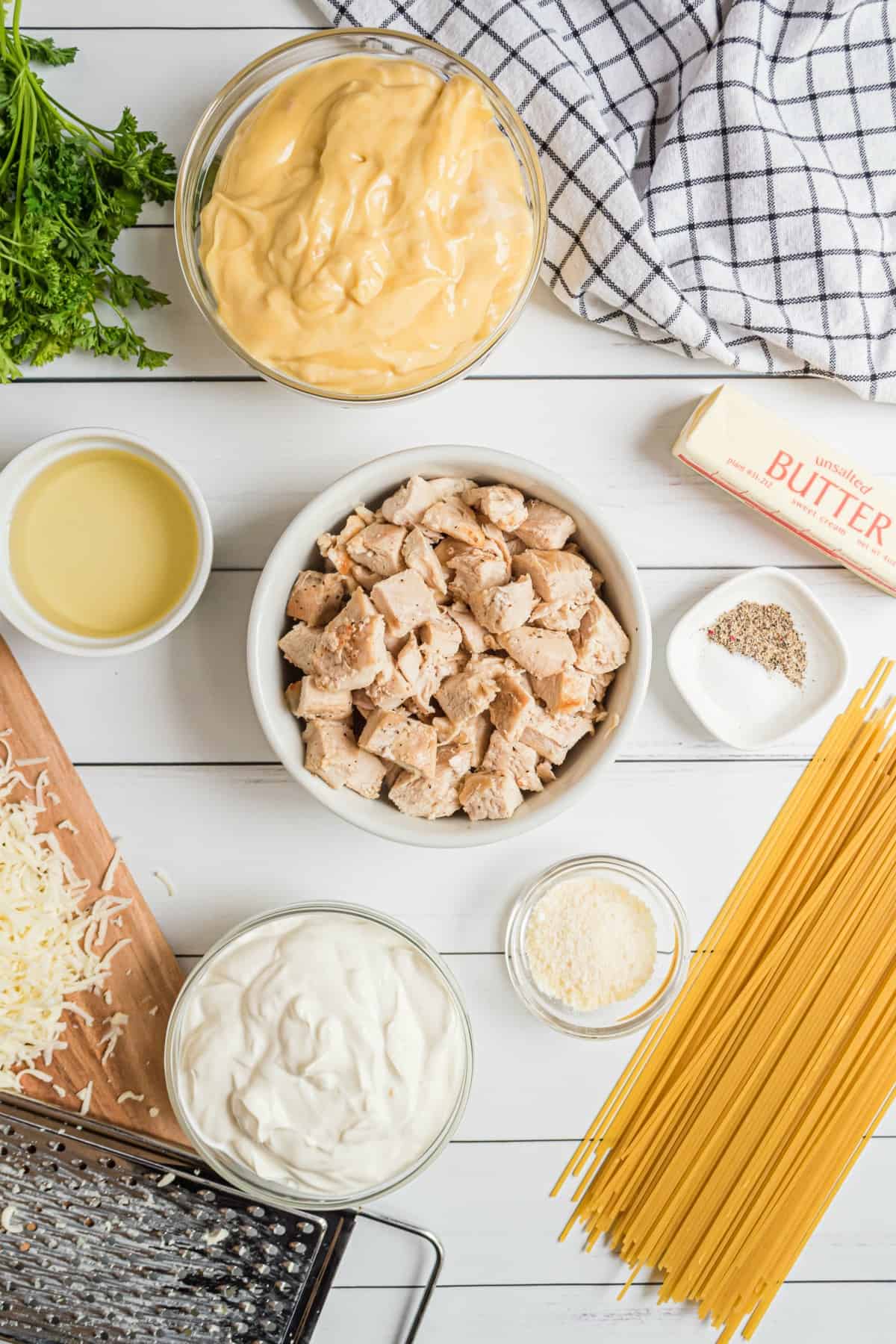 Ingredients you'll need to make chicken tetrazzini, including cooked chicken, pasta, cream of chicken soup and more.