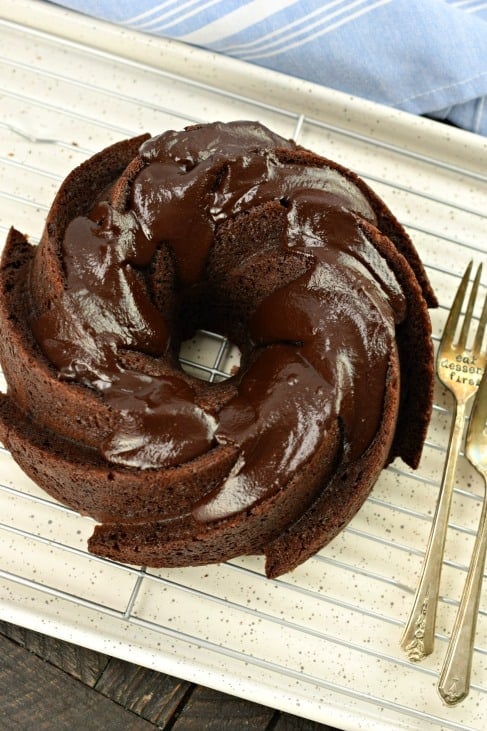 Chocolate Pound Cake in bundt pan with chocolate ganache on a wire rack to cool.