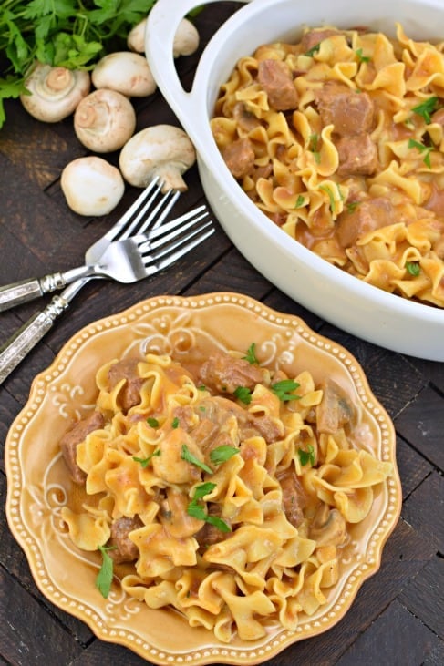 Instant Pot Beef Stroganoff served on a yellow plate with a dish of beef stroganoff in a white bowl.