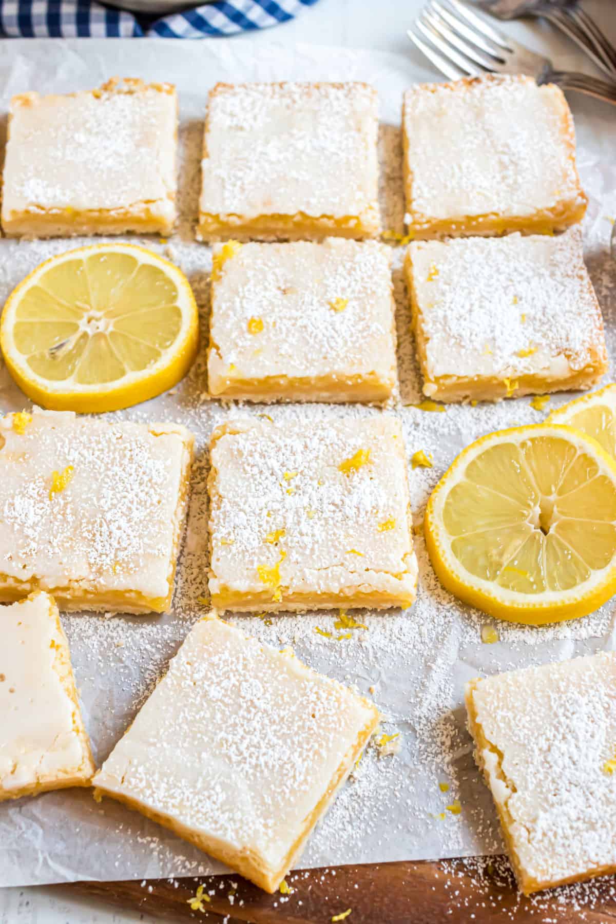 Lemon bars cut into squares and topped with powdered sugar.