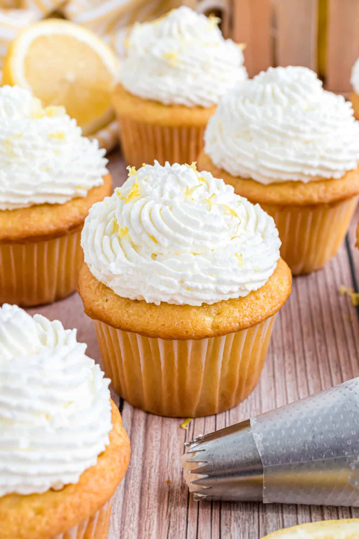 Lemon whipped cream frosting on a lemon cupcake.