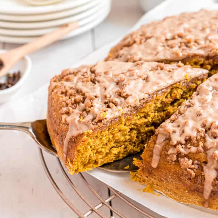 Moist, delicious Pumpkin Coffee Cake piled high with a sweet Cinnamon Steusel and cinnamon glaze. Easy recipe with freezer friendly options too!