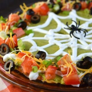 7 layer taco dip with halloween spider web.