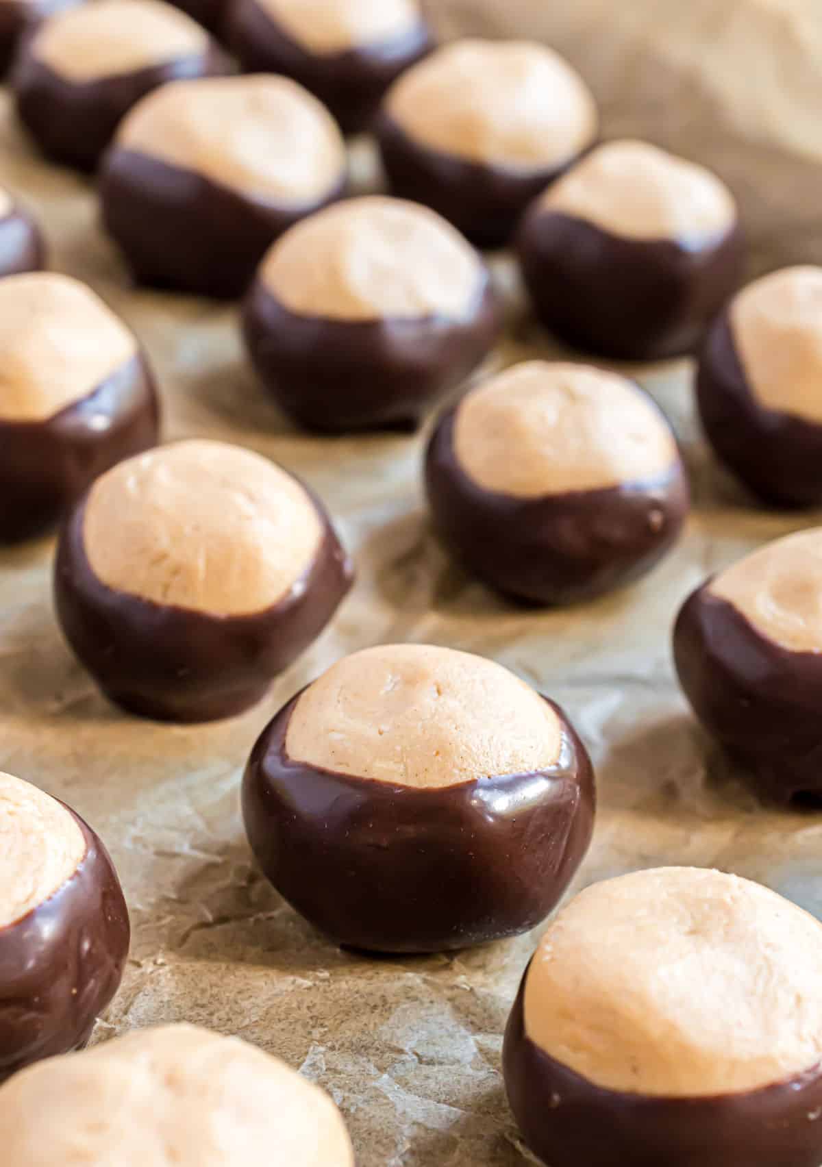 Homemade buckeyes on parchment paper.