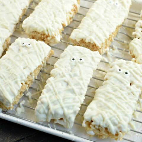 Rice krispie treats with white chocolate and decorated to look like mummies.