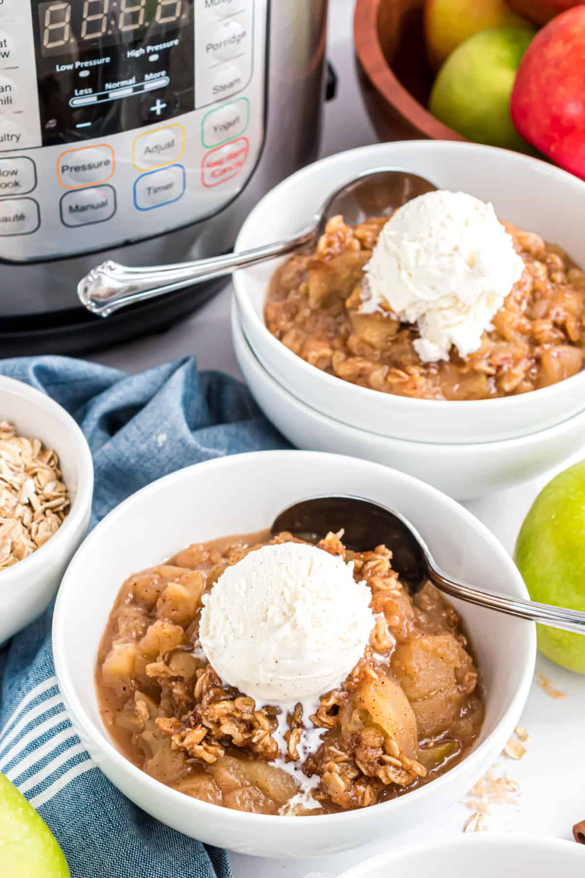 Apple crisp served with a scoop of vanilla ice cream.