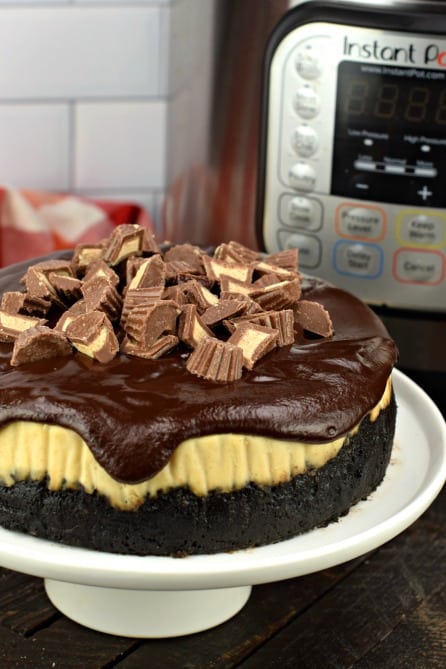 Instant Pot Peanut Butter Cheesecake with chocolate ganache and peanut butter cups on top