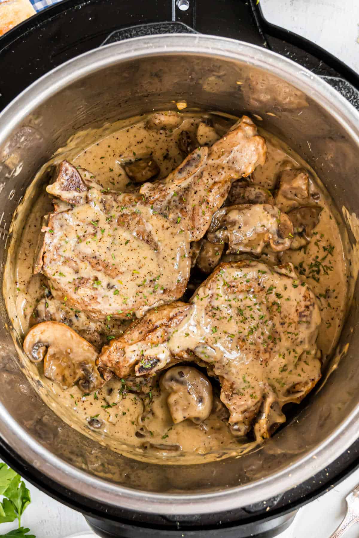 Pork chops in a pressure cooker with mushroom gravy.