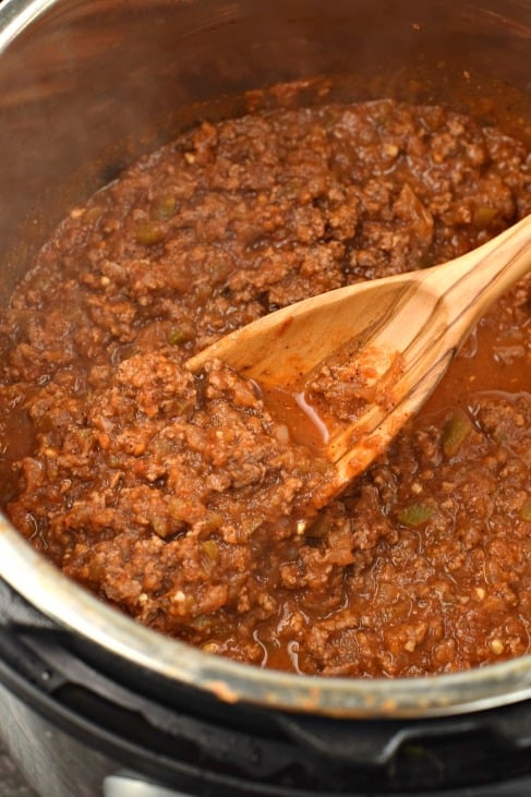 Pot with sloppy joes and wooden spoon.