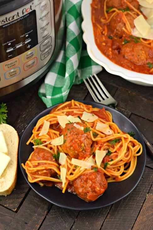 Instant Pot Spaghetti and Meatballs recipe on a plate with bread.