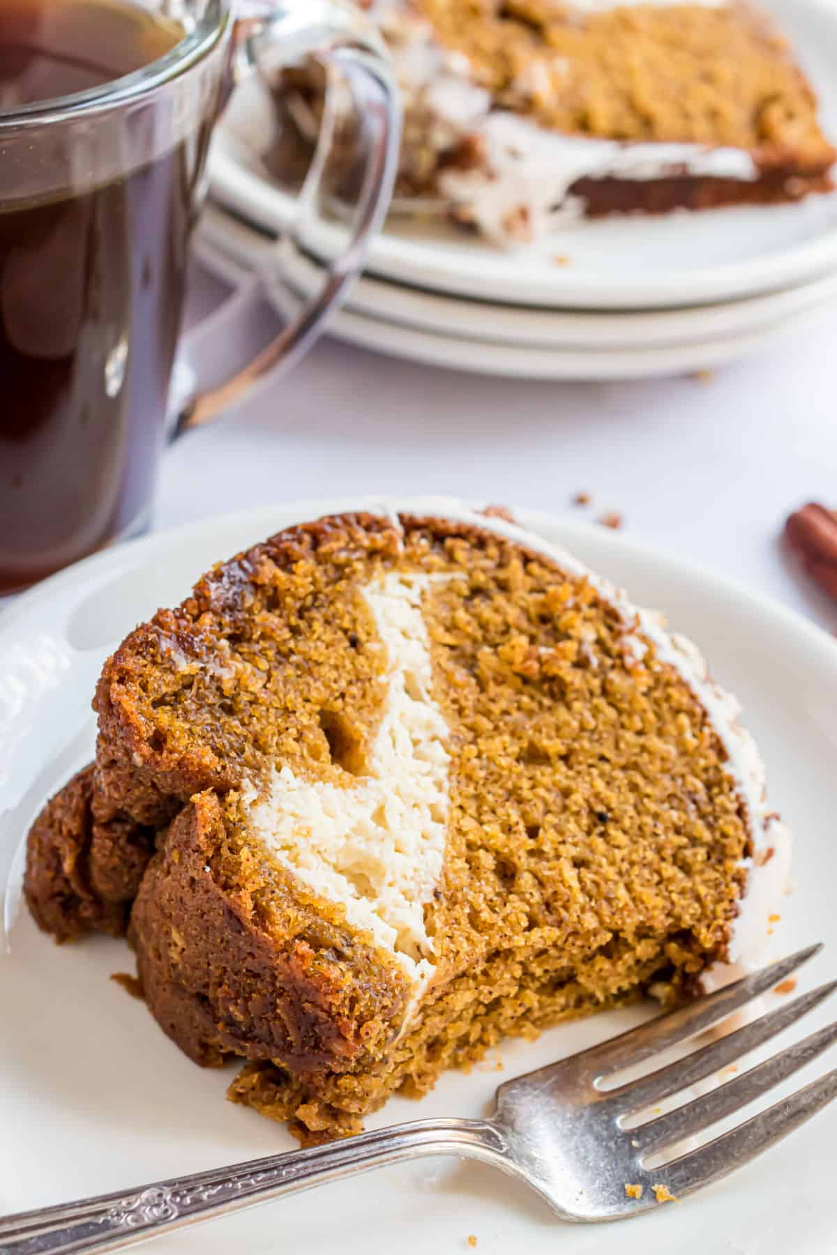 Slice of pumpkin cake with a bite taken out.