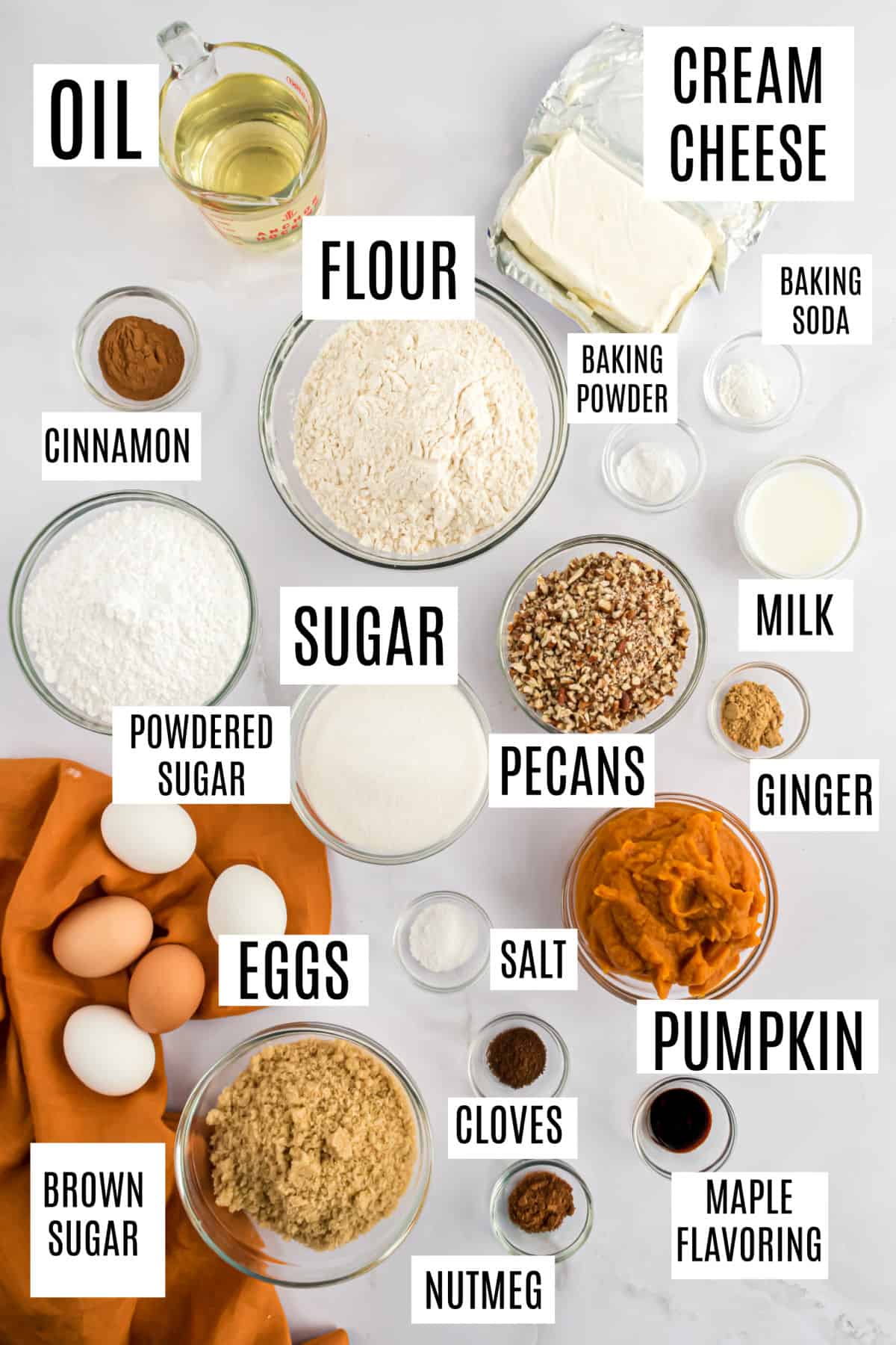 Ingredients needed to make pumpkin bundt cake with a cream cheese swirl.