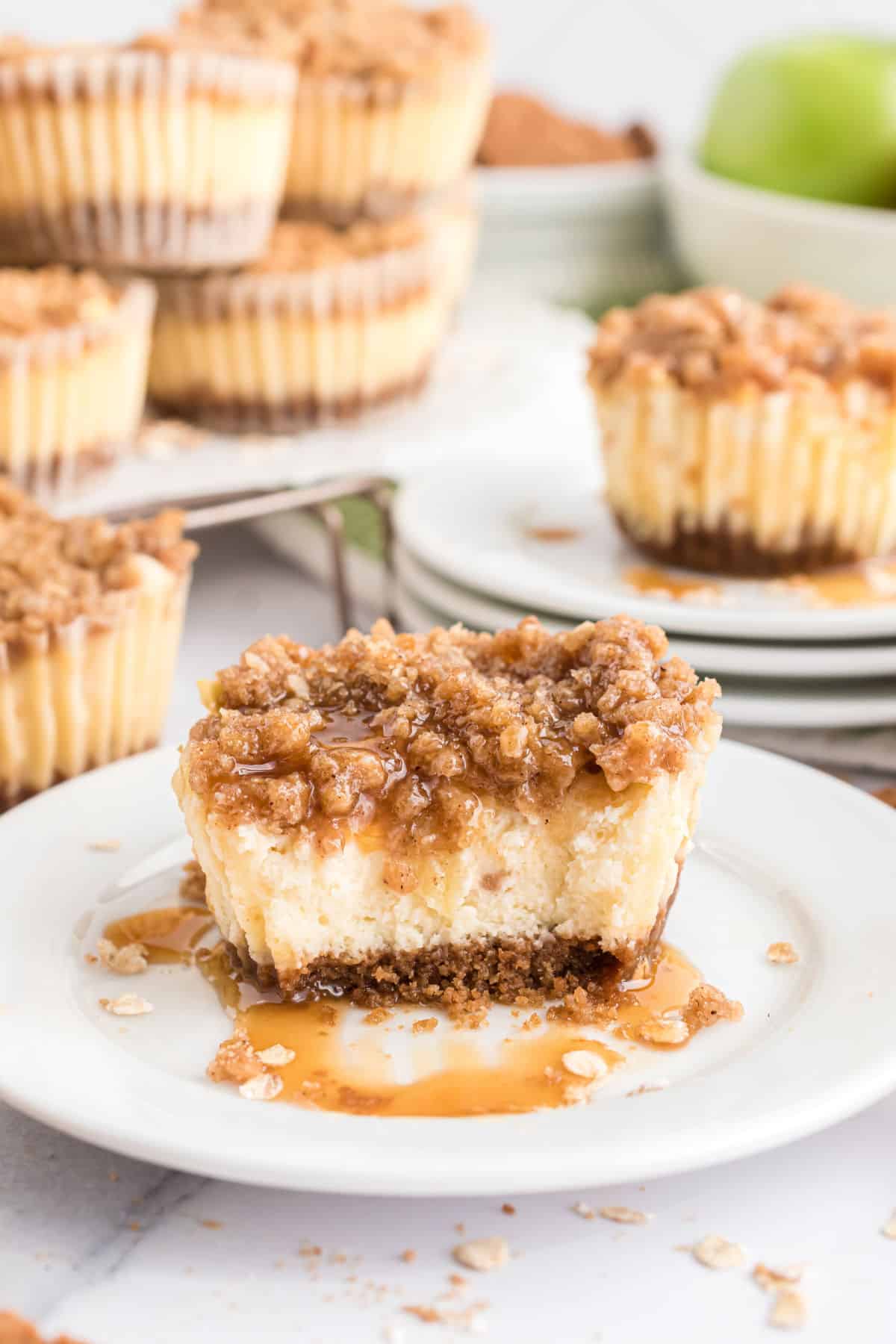 Mini apple cheesecake with a bite taken out.