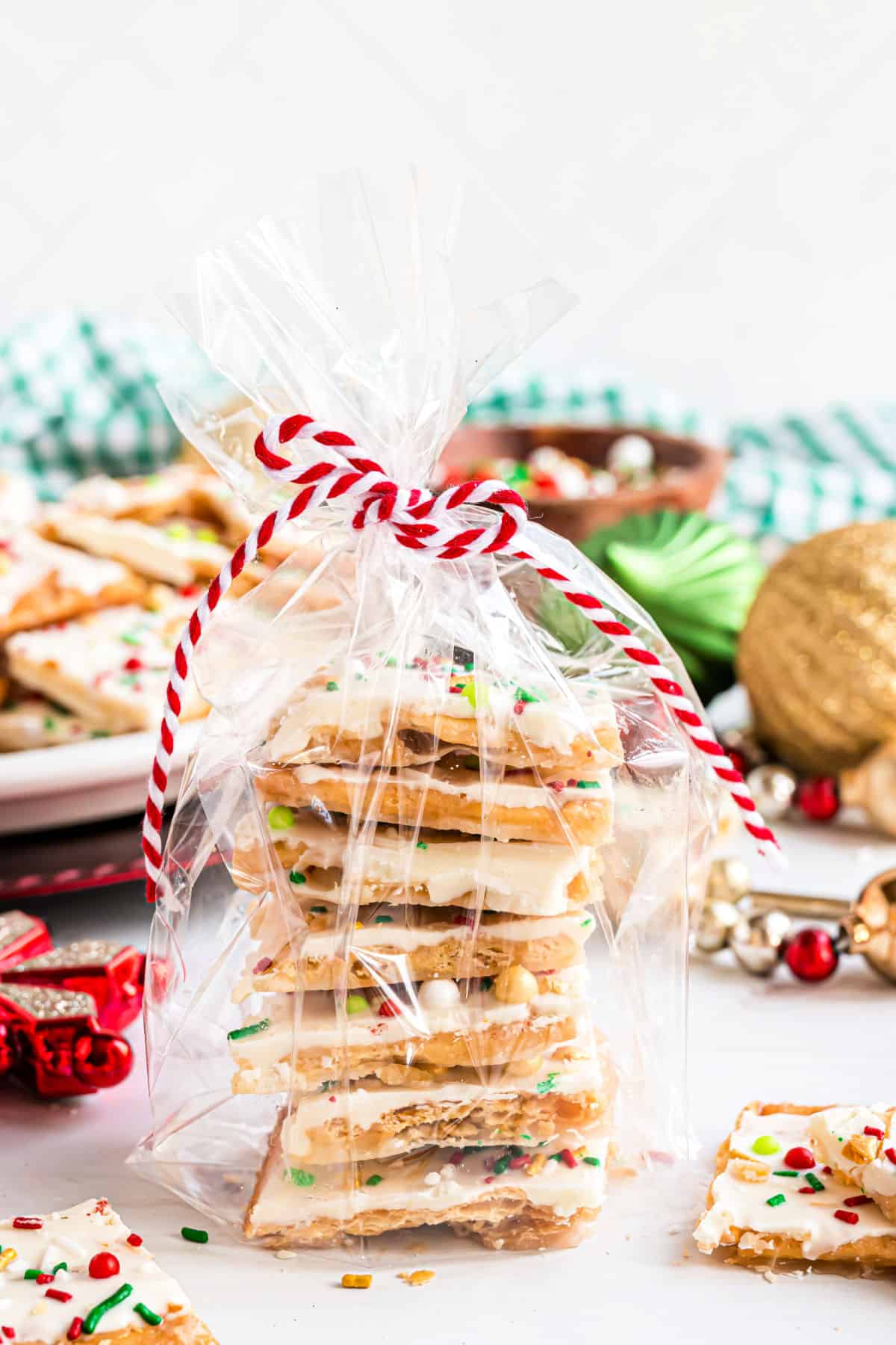 Stack of saltine toffee in a clear bag for a gift.