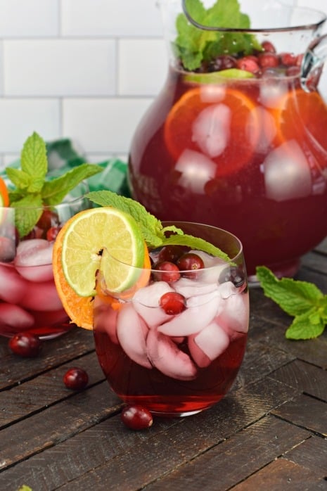 Easy, fun and fruity, Christmas Punch recipe. This holiday drink is flavored with cranberry, orange, lime, and my secret ingredient, almond extract! Add rum for a festive spiked cocktail.