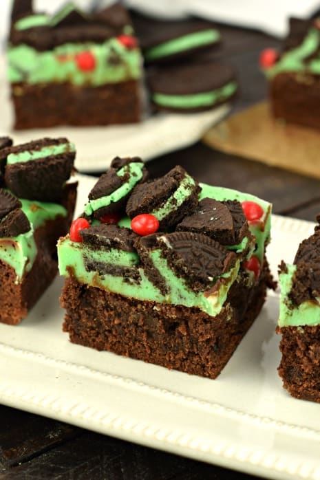 Thick and fudgy Chocolate Brownies. Grinch brownies with a green mint ganache, mint Oreos, and red hot candies! Perfect for Christmas.