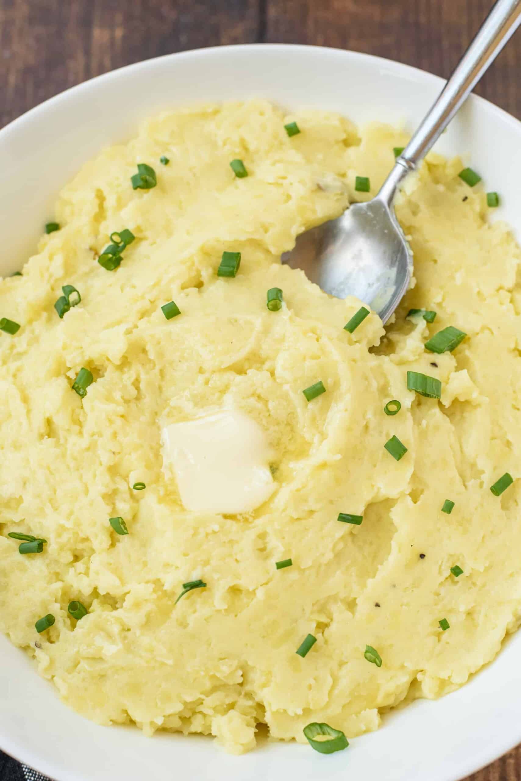 Creamy Instant Pot Mashed Potatoes served with butter and chives