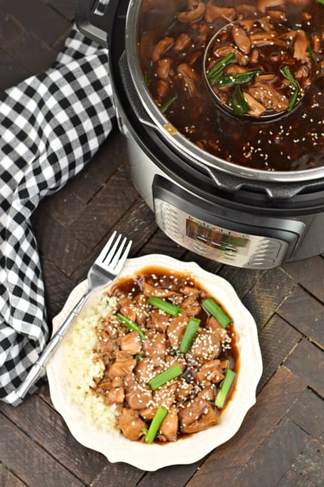 Plate of Mongolian Chicken with Instant Pot. Served over rice with sesame seeds and green onion