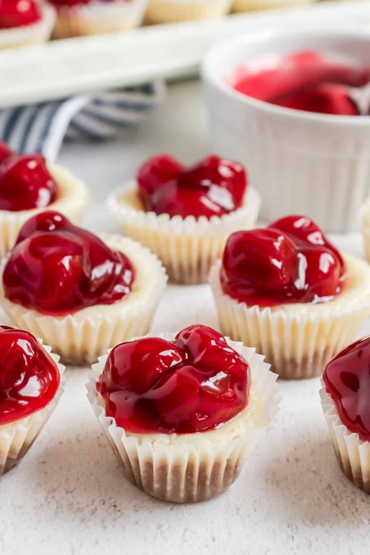 Mini cheesecakes topped with cherry pie filling.