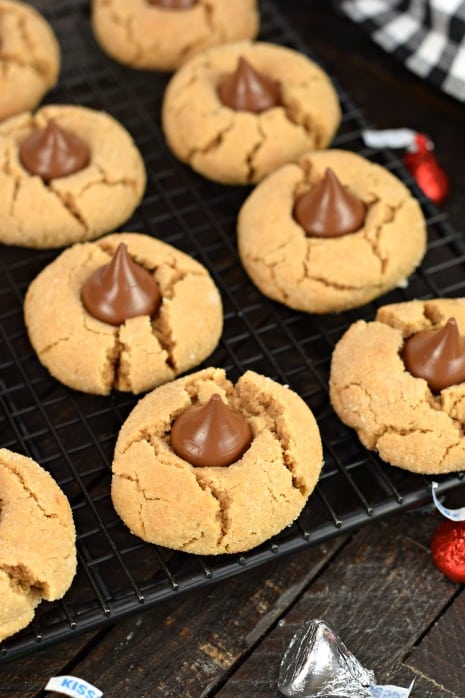 Wire rack with peanut butter blossom cookies.