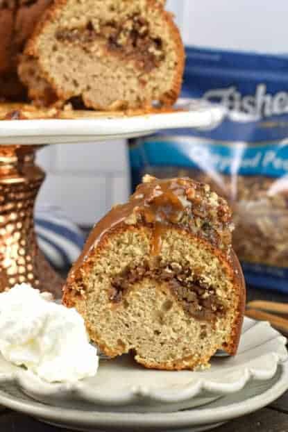 Pecan Pie Bundt Cake with pecan pie filling swirled within and topped with caramel.