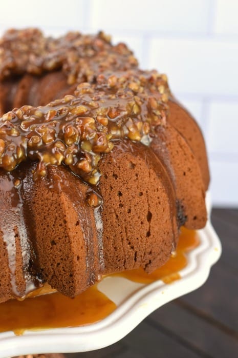 Bundt cake with pecan pie topping and swirl with caramel sauce.