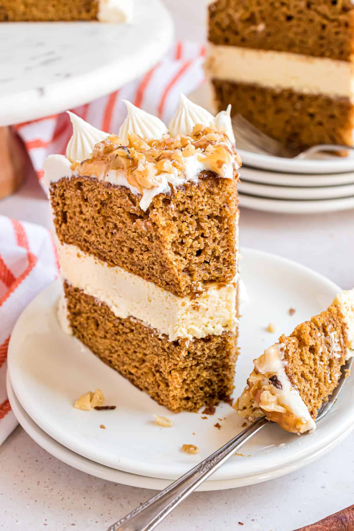 Slice of pumpkin cheesecake cake with a bite taken out.