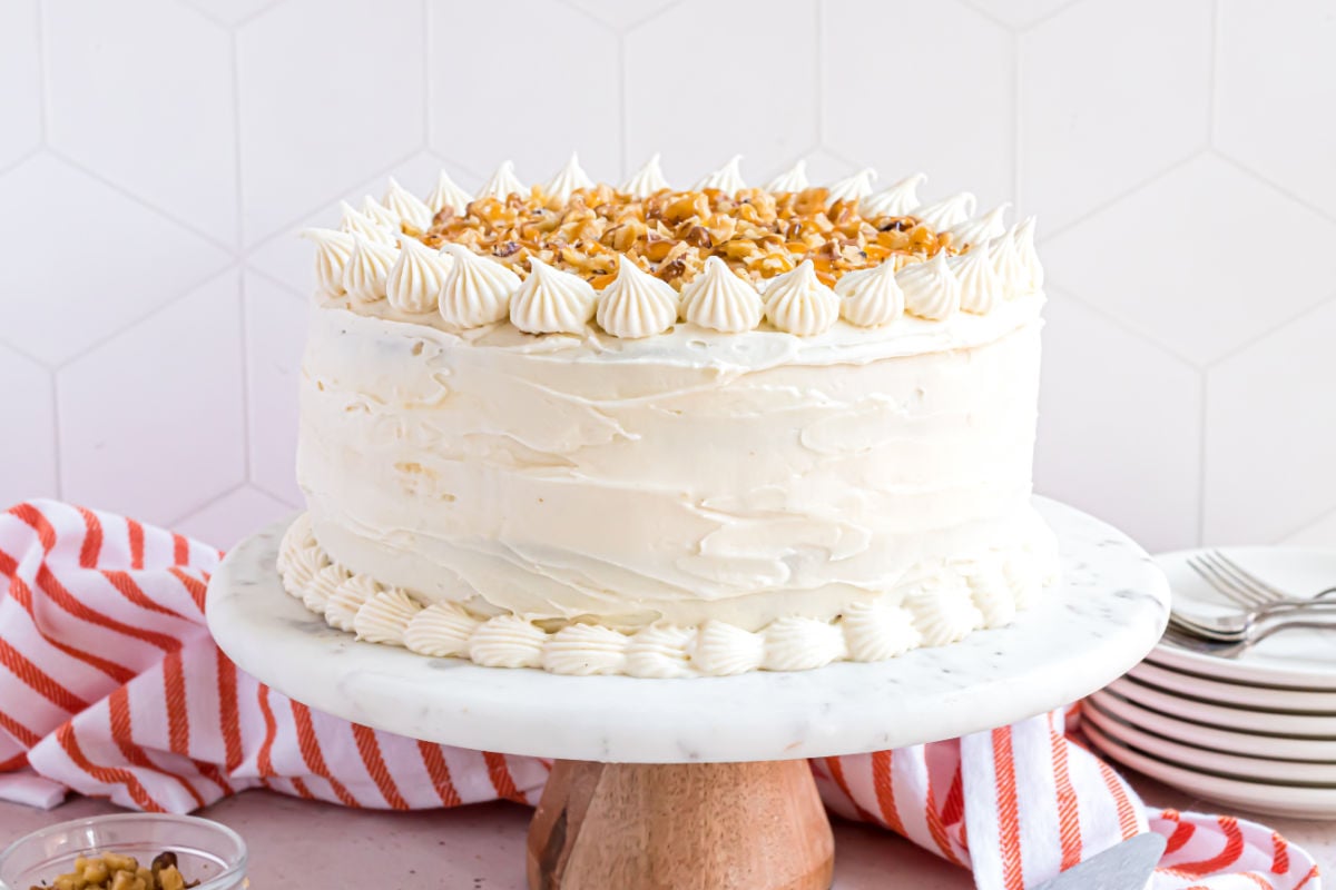 Pumpkin cheesecake cake covered in cream cheese frosting.