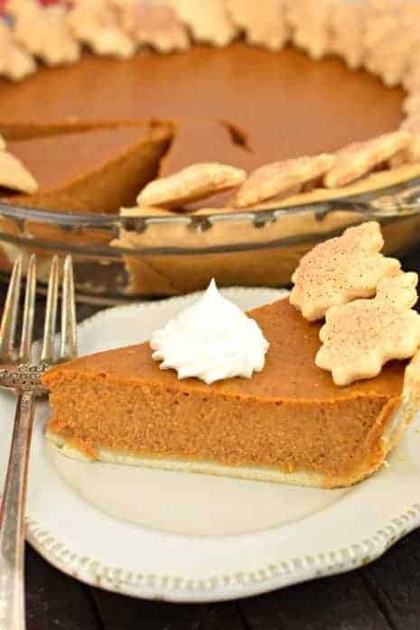 Perfect slice of pumpkin pie topped with homemade whipped cream.