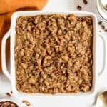 Sweet potato casserole in a square white baking dish.