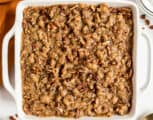 Sweet potato casserole in a square white baking dish.