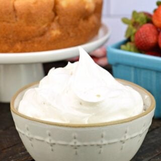 Homemade whipped cream in a white bowl.