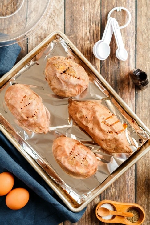 Sweet potatoes on foil lined baking sheet.