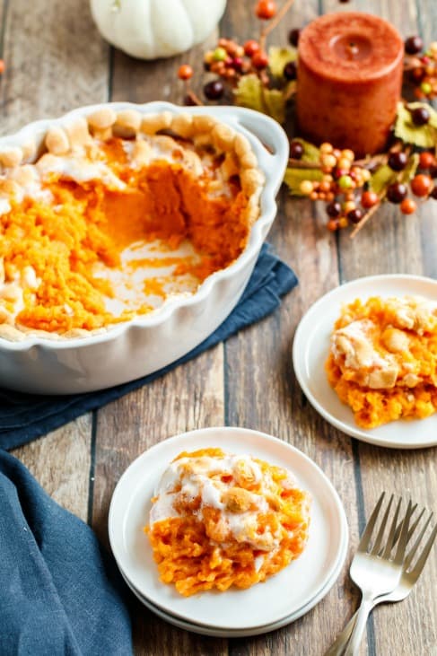 Two plates with scoops of sweet potato casserole and marshmallow.