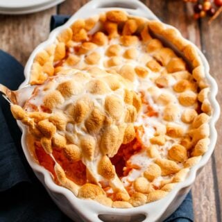 Sweet potato casserole with marshmallows in a white baking dish.