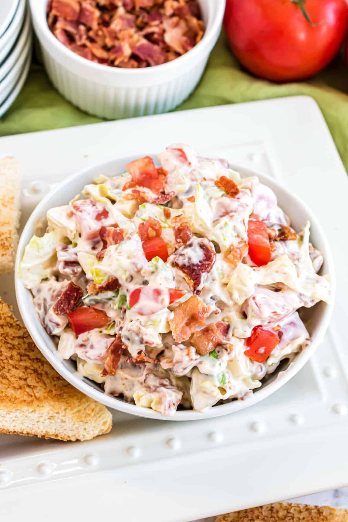 Bacon lettuce tomato dip in a white bowl.