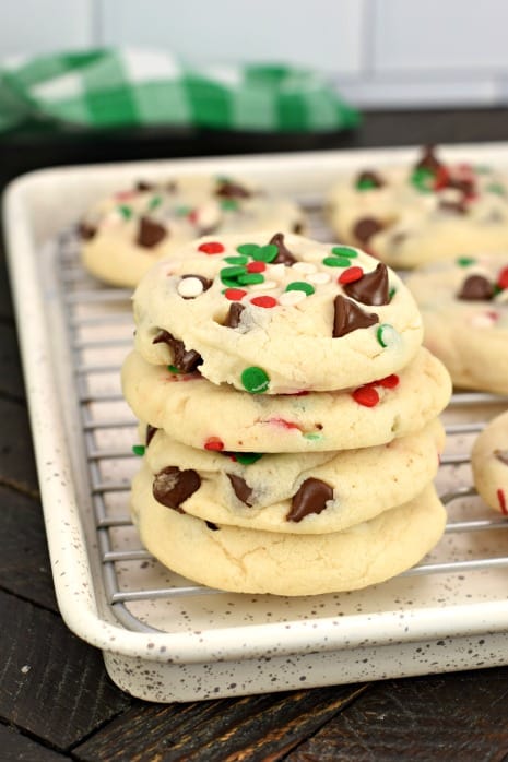Stack of four christmas cookies on a baking sheet with wire rack.