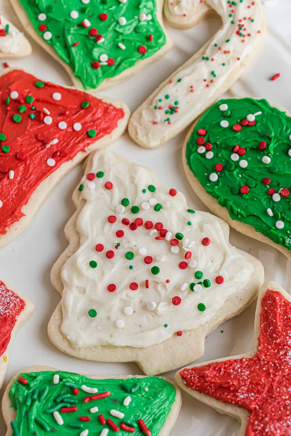 Christmas shaped sugar cookies with colorful frosting and sprinkles.