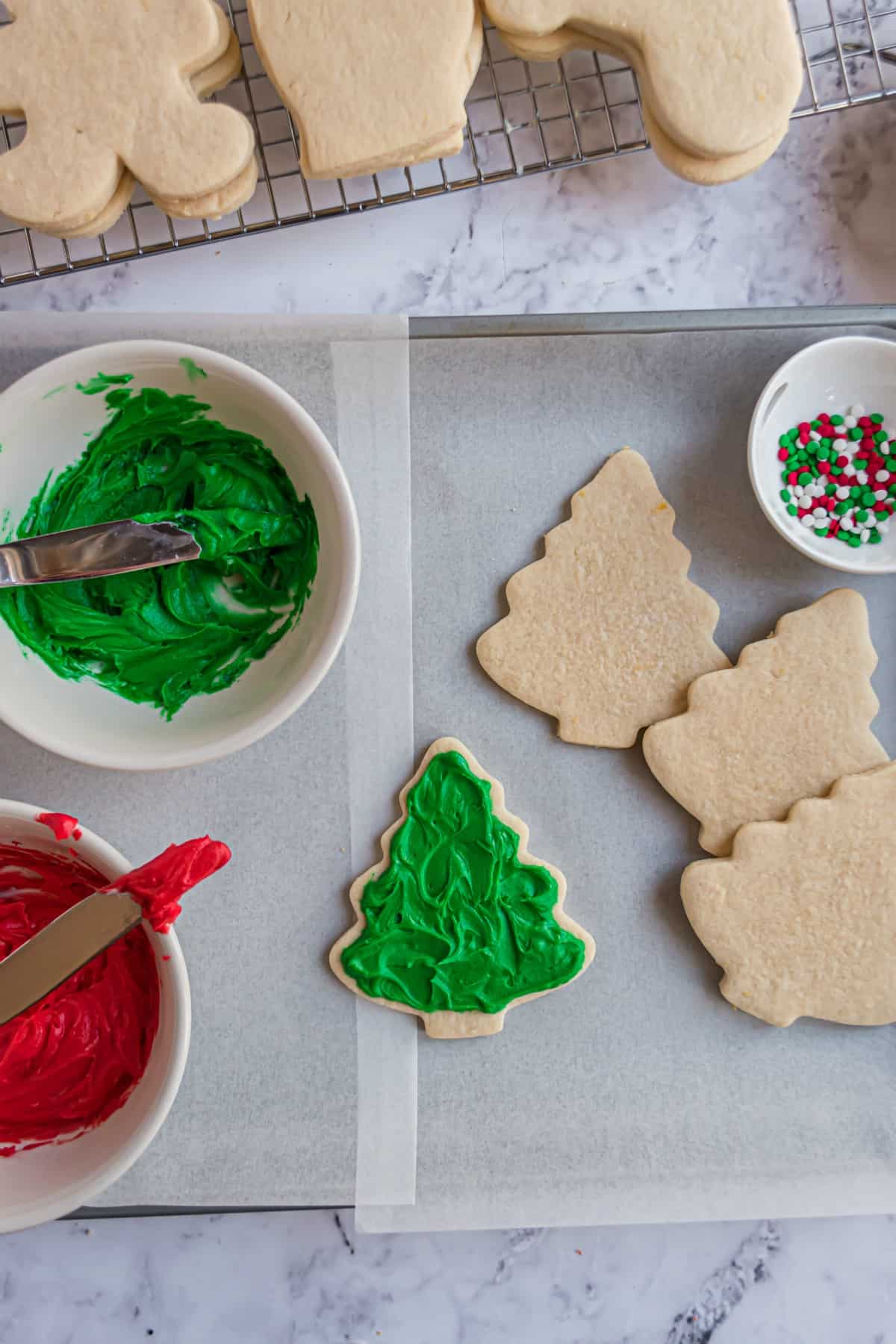 Christmas tree cut out sugar cookies with vanilla bean frosting tinted green.