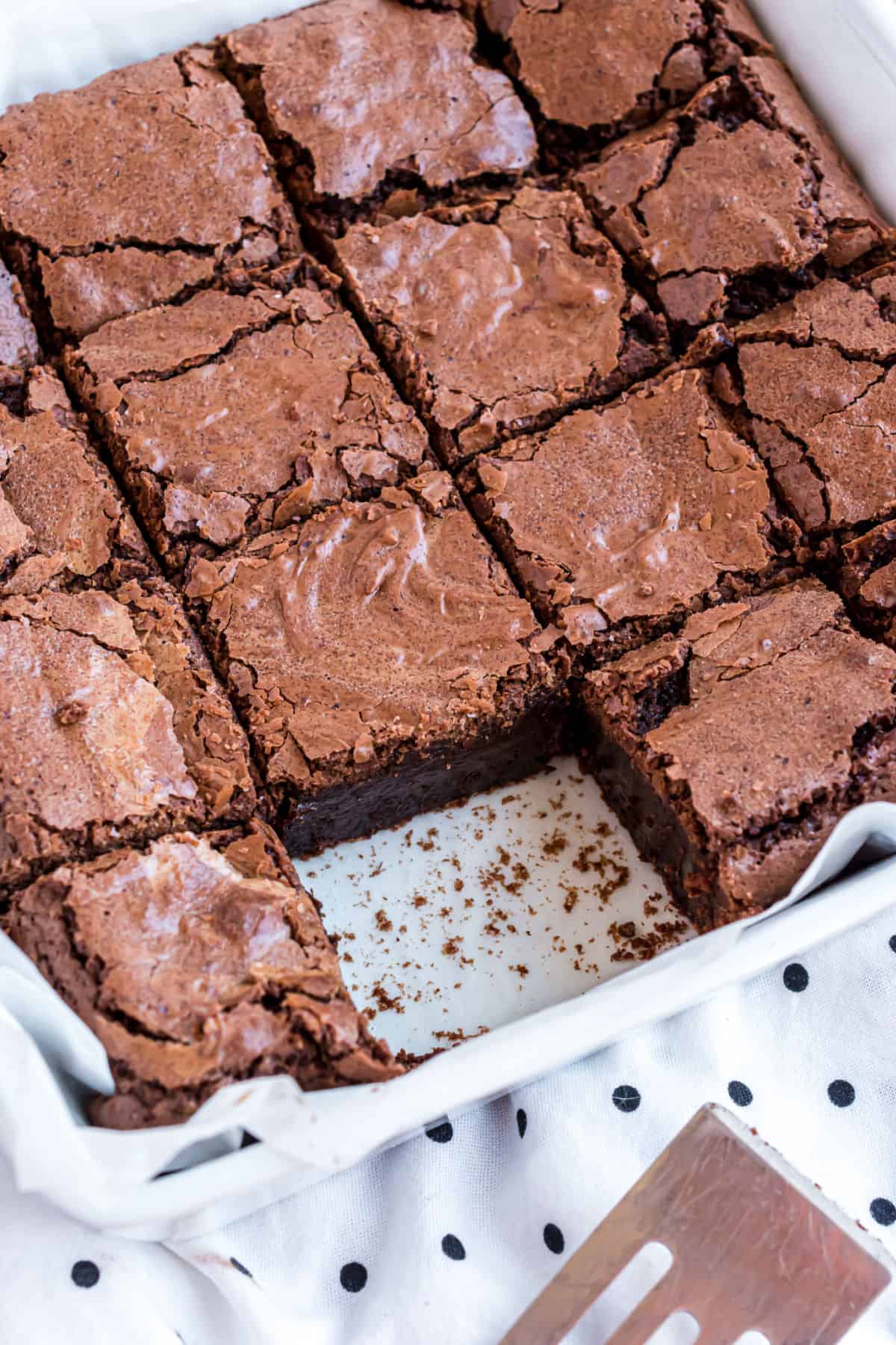 Pan of fudgy brownies with one slice removed.