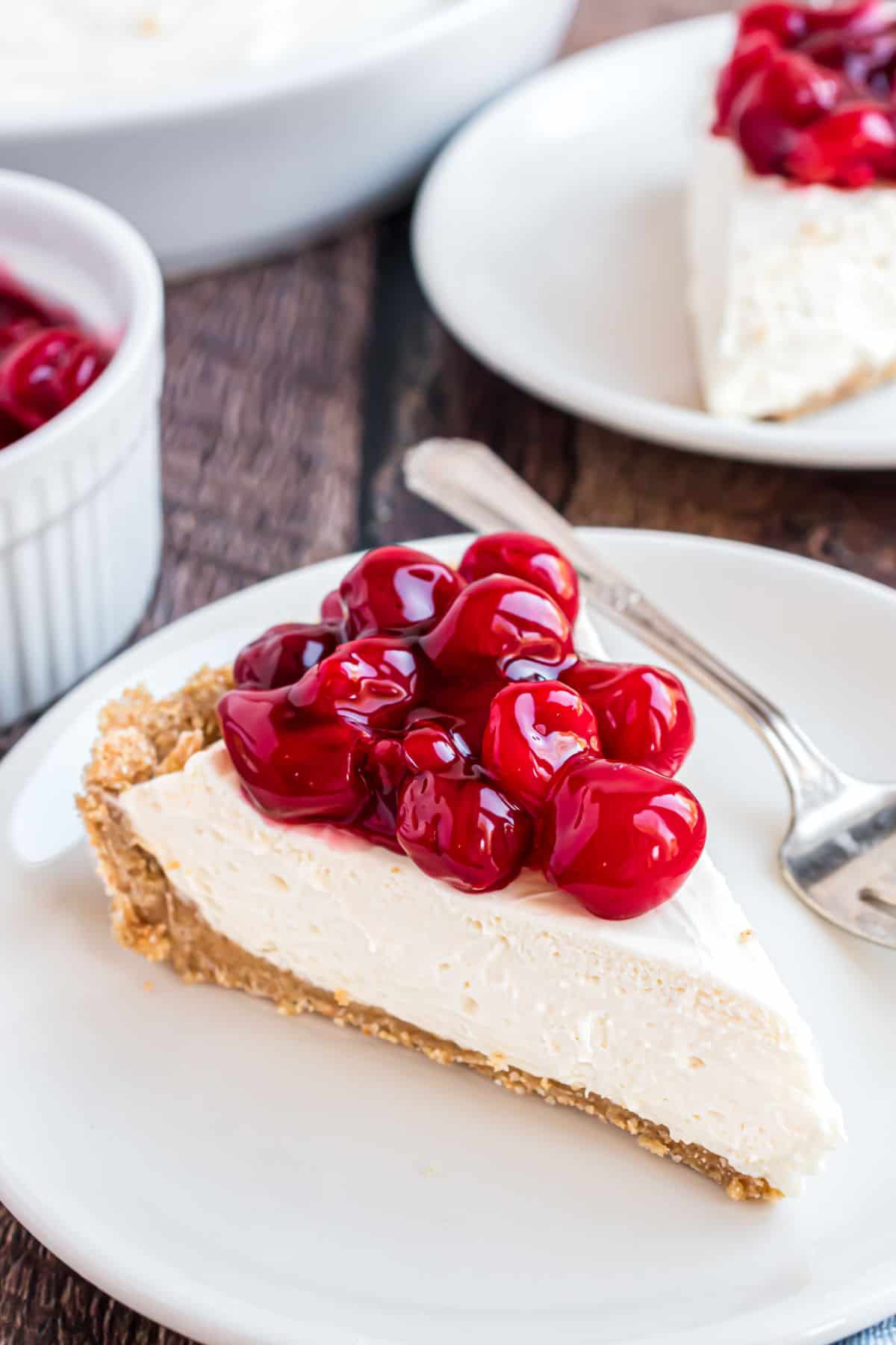 No bake cherry cheesecake slice on a white plate.