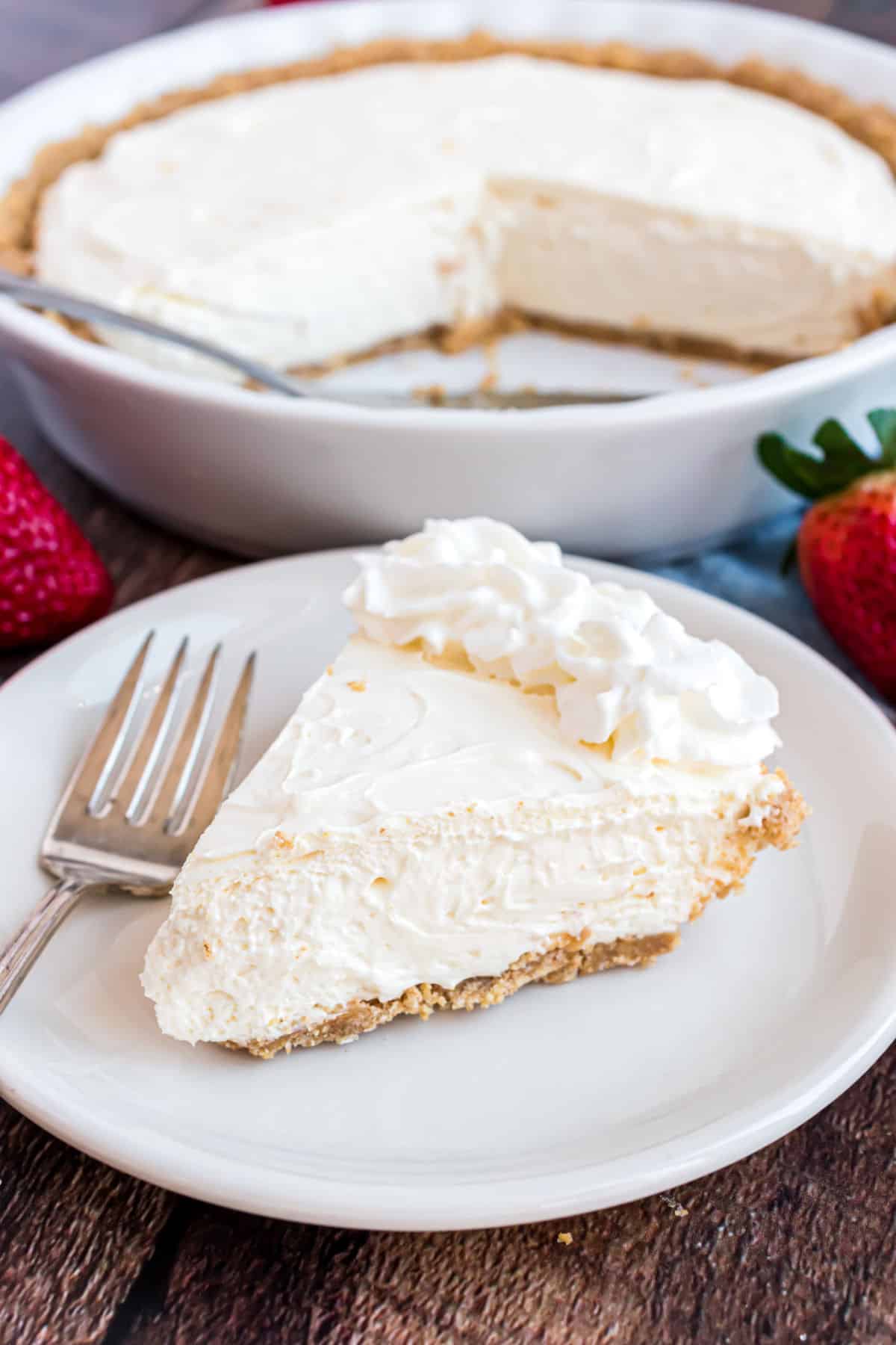 No bake cheesecake sliced and garnished with whipped cream.