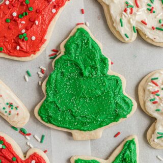 Cut out sugar cookies shaped for christmas and decorated with red and green frosting.