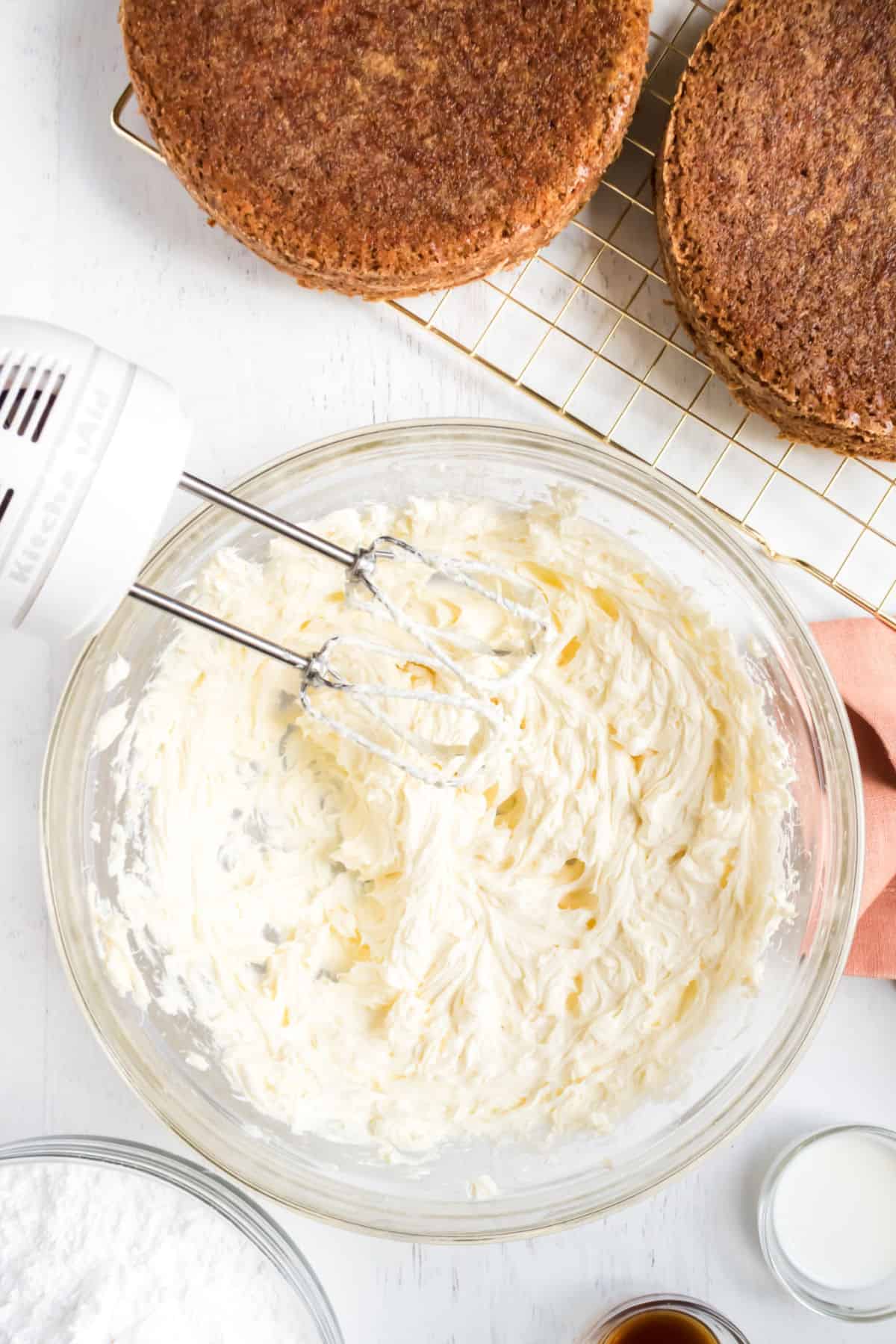 Cream cheese frosting for carrot cake in a glass bowl.