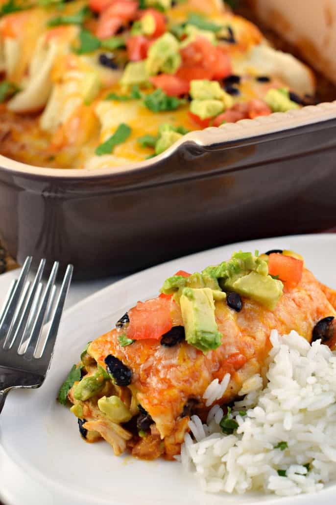 Chicken avocado enchilada served on a plate with cilantro lime rice.