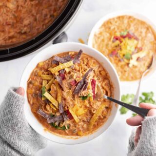 Chicken taco soup in a white dinner bowl.